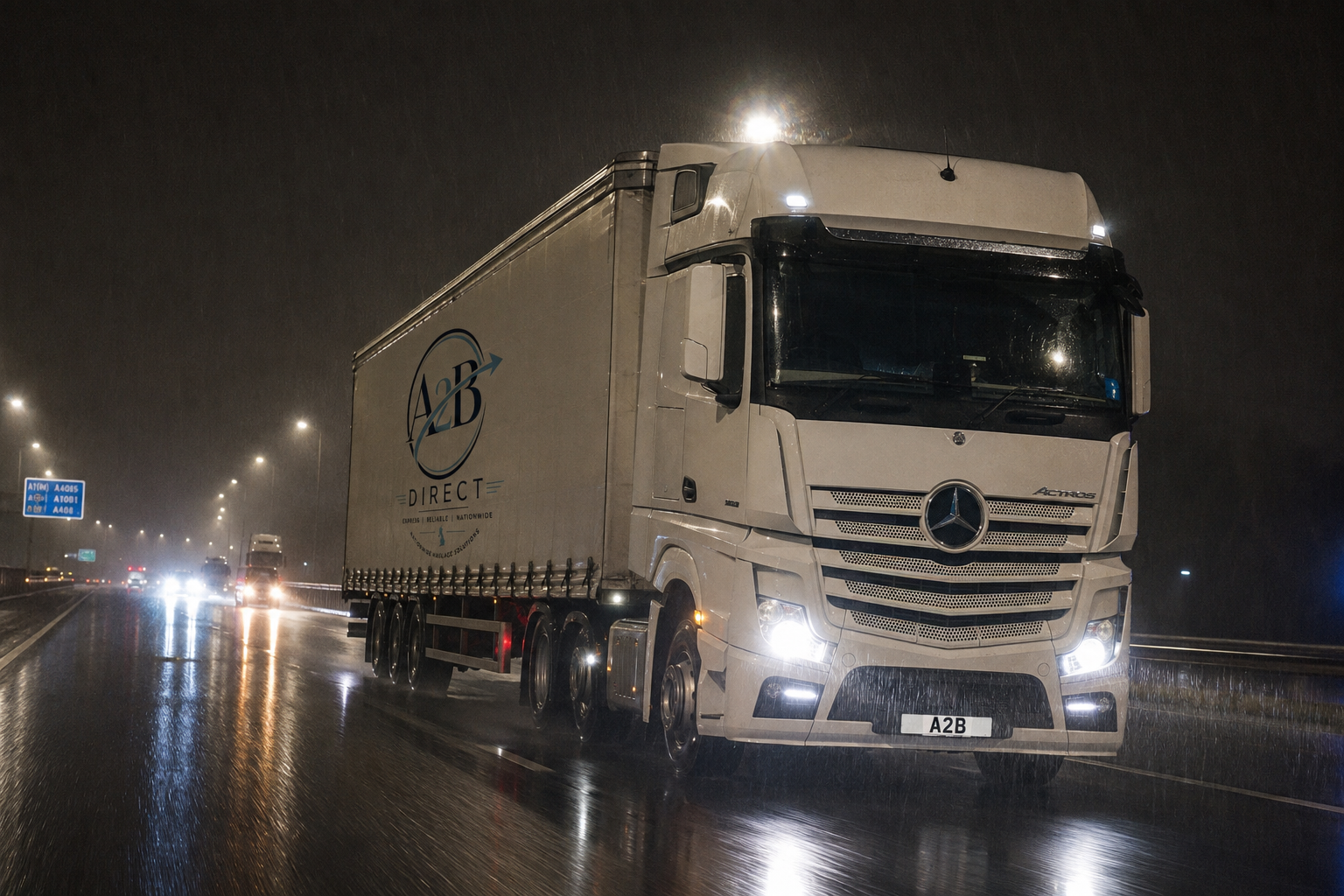 A2B Direct Mercedes Actros articulated lorry on a wet UK motorway at night